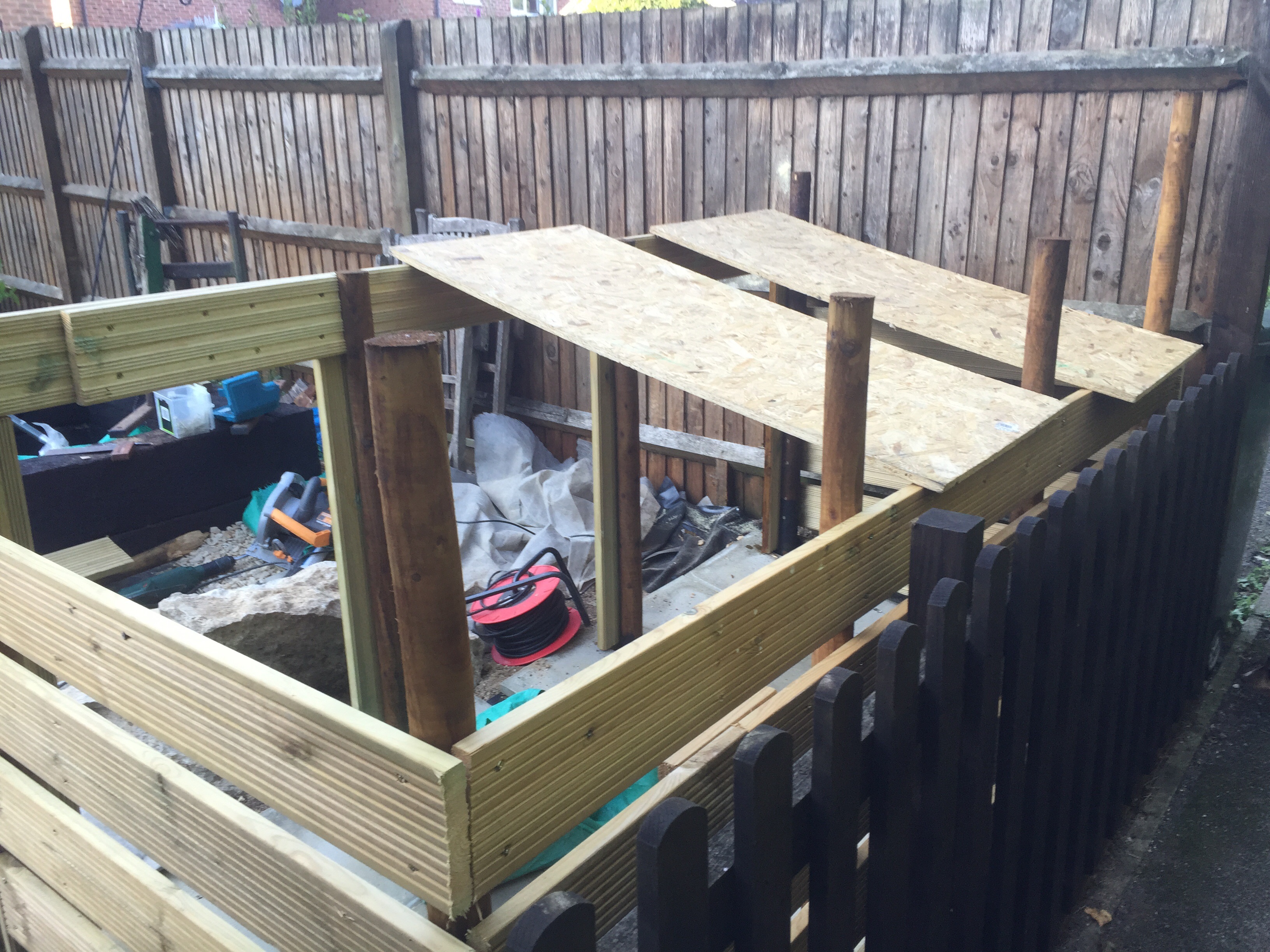 Picture of the composting bins with the front cladding taken from the rear